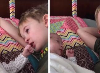 Un niño llora mientras le canta una canción de cuna a su hermanita menor